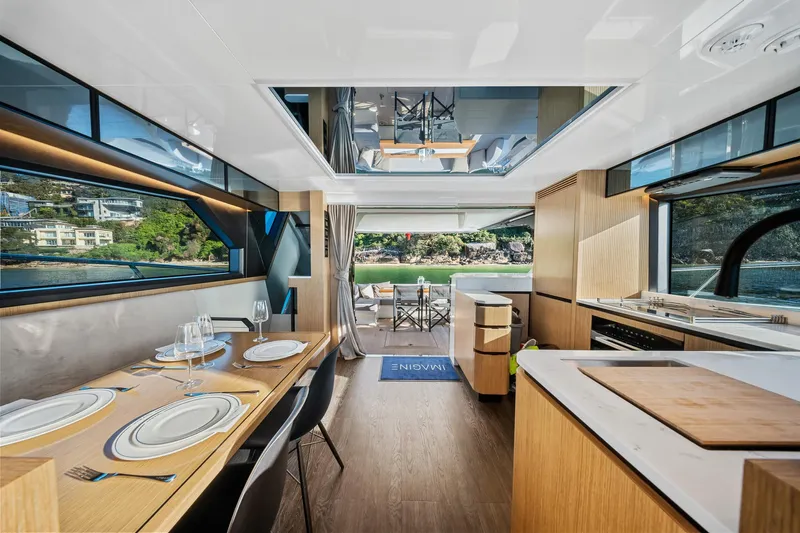 2023 Pearl 62 Luxury Yacht Yacht Photos Pics Luxurious interior of 2023 Pearl 62 yacht with dining area and scenic views.