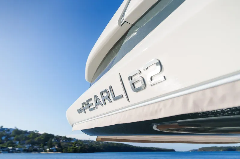2023 Pearl 62 Luxury Yacht Yacht Photos Pics 2023 Pearl 62 yacht close-up with scenic ocean backdrop.