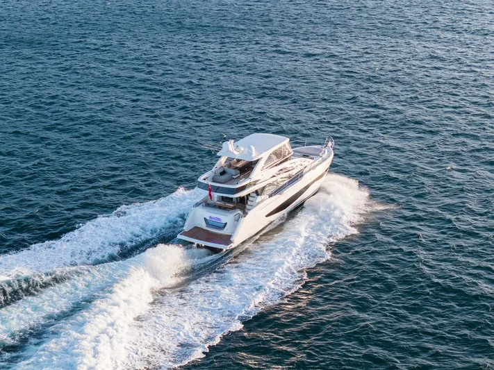 2023 Pearl 62 Luxury Yacht Yacht Photos Pics 2023 Pearl 62 yacht cruising on open sea, creating white wake trails.