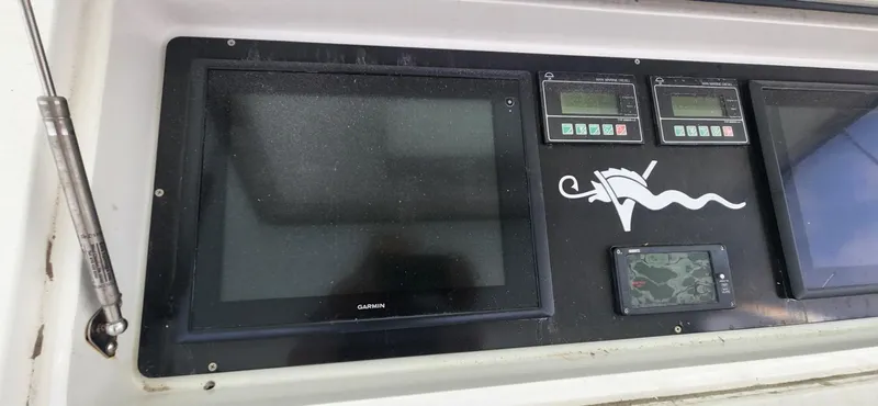  Yacht Photos Pics Control panel of a 2004 Viking 52 Convertible boat with Garmin display.