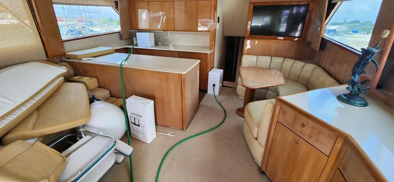  Yacht Photos Pics Interior of 2004 Viking 52 Convertible yacht with kitchen, seating area, and TV.