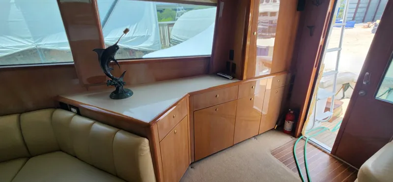  Yacht Photos Pics Interior of 2004 Viking 52 Convertible yacht with wooden cabinetry and leather seating.