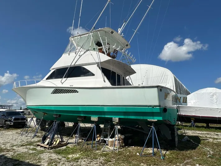  Yacht Photos Pics 2004 Viking 52 Convertible boat on stands, clear sky background.