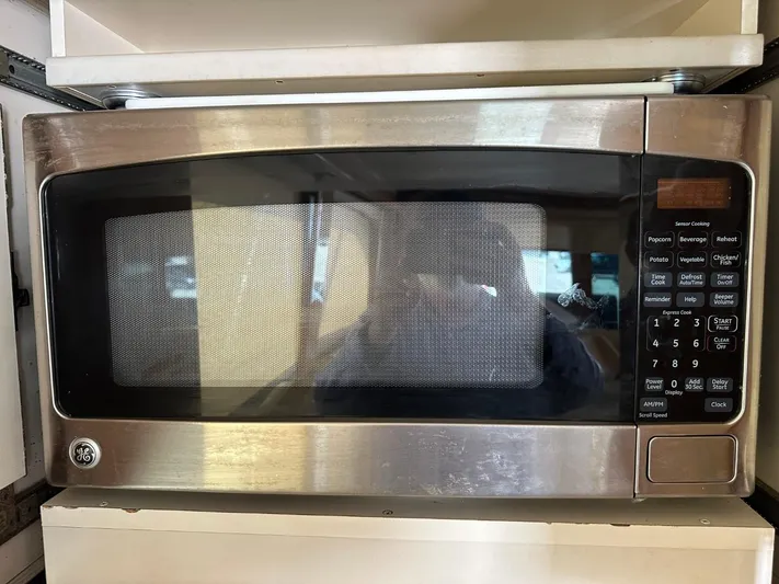  Yacht Photos Pics 2004 Viking 52 Convertible microwave oven with stainless steel finish and digital control panel.