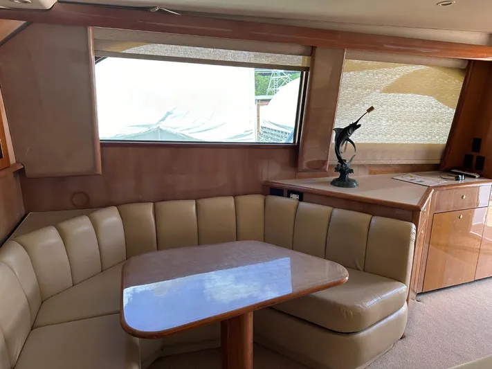  Yacht Photos Pics Interior of 2004 Viking 52 Convertible yacht with leather seating and wooden table.