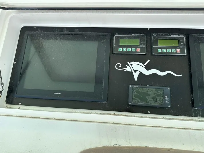  Yacht Photos Pics Control panel of a 2004 Viking 52 Convertible boat with Garmin display.