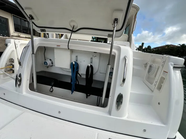  Yacht Photos Pics 2005 Tiara Yachts 3600 Sovran storage compartment with open hatch, docked by water.
