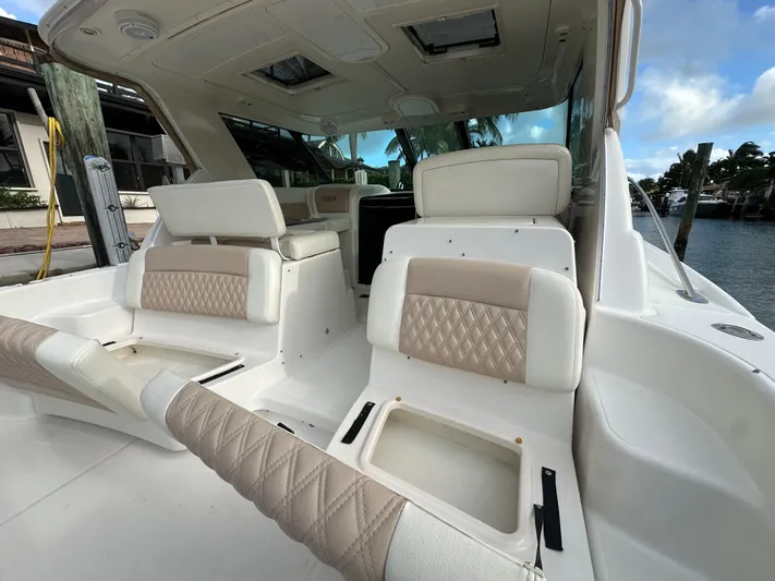 Yacht Photos Pics 2005 Tiara Yachts 3600 Sovran interior with beige and white seating, docked by the water.