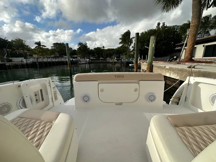  Yacht Photos Pics 2005 Tiara Yachts 3600 Sovran boat interior with seating, docked by a scenic waterfront.