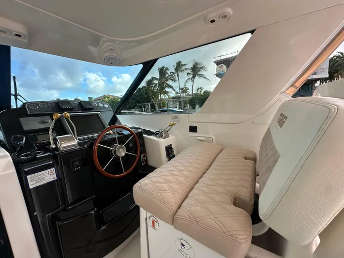  Yacht Photos Pics 2005 Tiara Yachts 3600 Sovran helm with leather seating and wooden steering wheel.