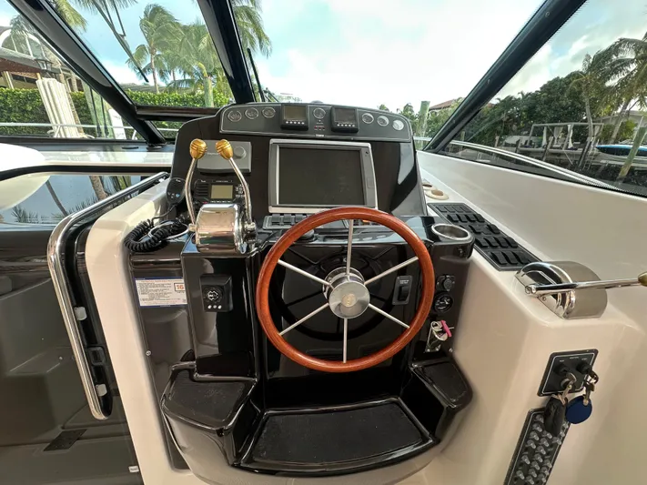  Yacht Photos Pics Helm of 2005 Tiara Yachts 3600 Sovran with wooden steering wheel and navigation controls.