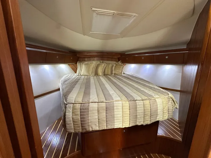  Yacht Photos Pics Luxurious cabin interior of 2005 Tiara Yachts 3600 Sovran with cozy bed and ambient lighting.