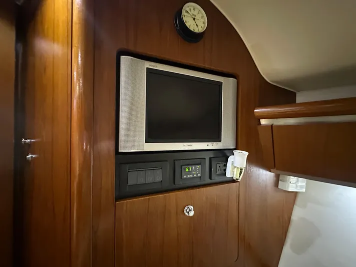  Yacht Photos Pics 2005 Tiara Yachts 3600 Sovran interior with TV and clock on wooden panel.
