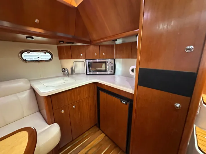  Yacht Photos Pics 2005 Tiara Yachts 3600 Sovran interior kitchen with wood cabinetry and modern appliances.