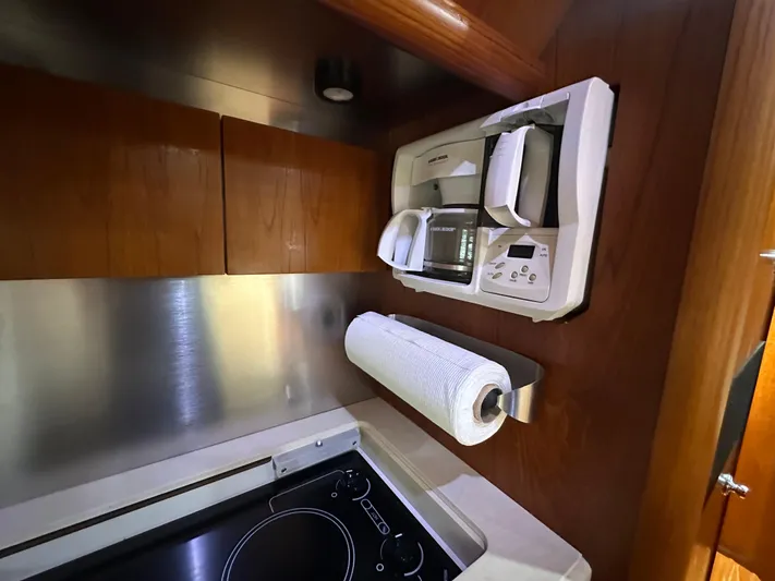  Yacht Photos Pics 2005 Tiara Yachts 3600 Sovran kitchen with microwave, stove, and paper towel holder.