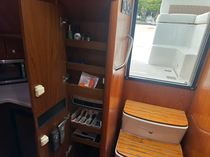  Yacht Photos Pics 2005 Tiara Yachts 3600 Sovran interior with wooden cabinetry and storage shelves.