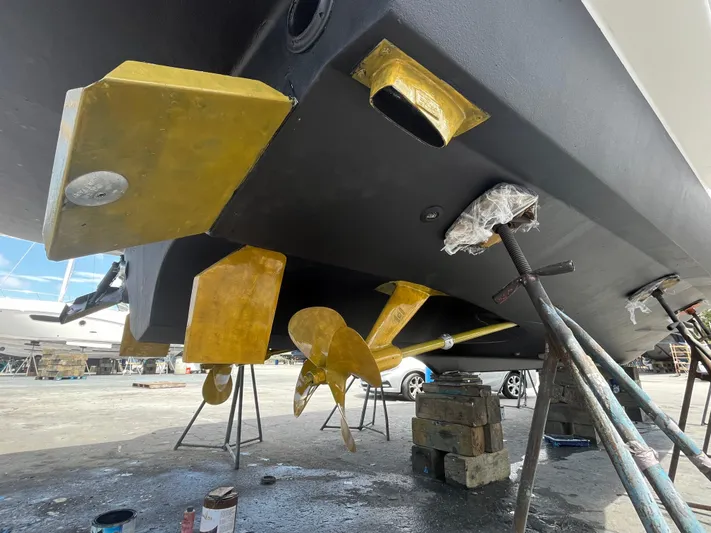  Yacht Photos Pics 2005 Tiara Yachts 3600 Sovran underbody with propellers and supports in a boatyard.