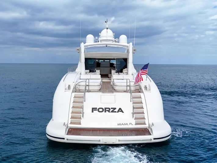  Yacht Photos Pics Luxury Mangusta 108 yacht from 2002 cruising in open sea, rear view.