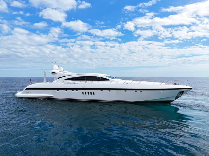 Yacht Photos Pics Luxury 2002 Mangusta 108 yacht cruising on open sea under blue sky.