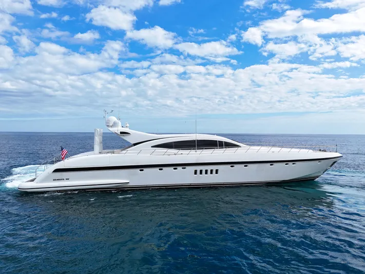  Yacht Photos Pics Luxury 2002 Mangusta 108 yacht cruising on open sea under blue sky.