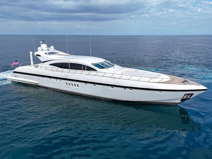  Yacht Photos Pics Luxury 2002 Mangusta 108 yacht cruising on open sea under clear skies.
