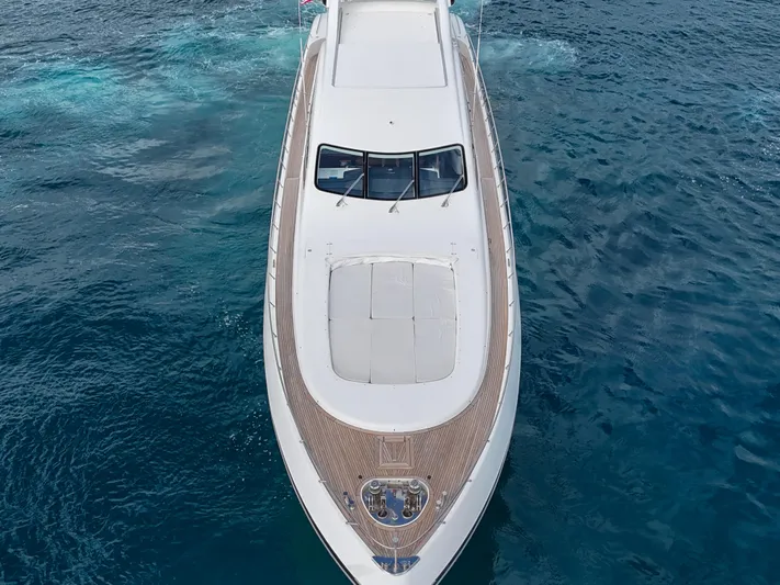  Yacht Photos Pics Mangusta 108 yacht from 2002 cruising on open water, aerial view.