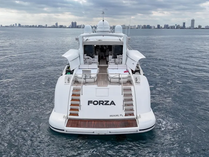  Yacht Photos Pics Luxury 2002 Mangusta 108 yacht "Forza" on open water, Miami skyline in background.