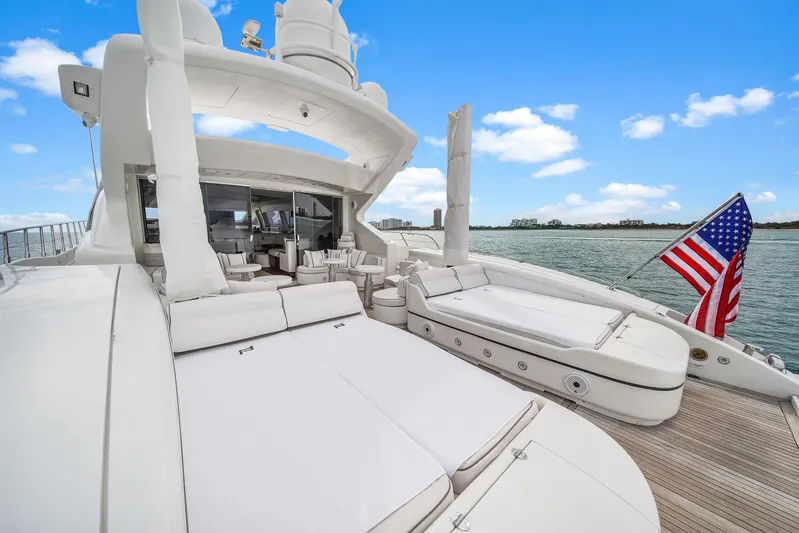  Yacht Photos Pics Luxurious 2002 Mangusta 108 yacht deck with sun loungers and American flag.