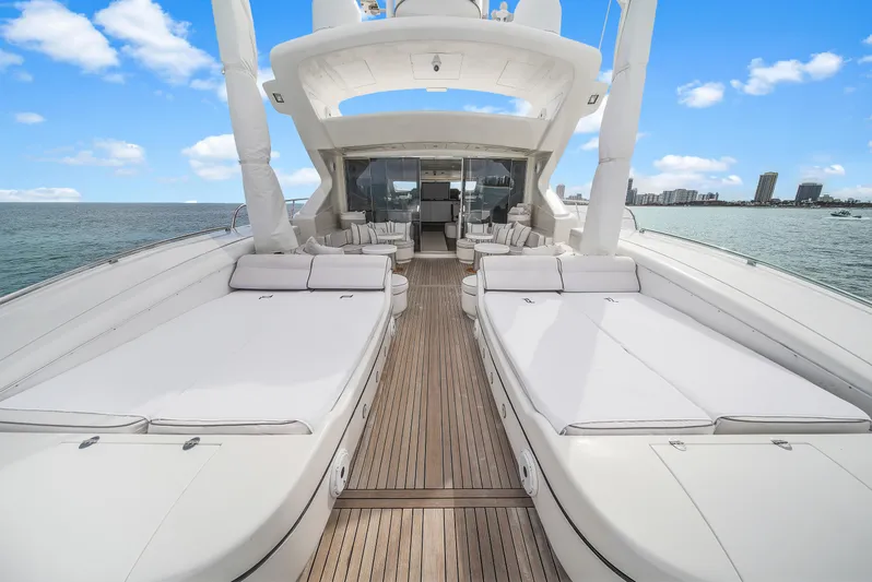  Yacht Photos Pics Luxurious 2002 Mangusta 108 yacht deck with sunbeds and ocean view.