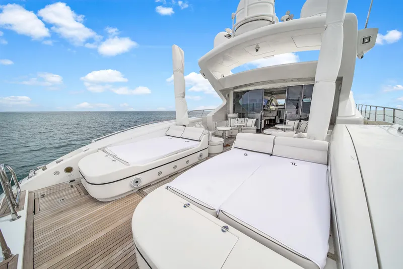  Yacht Photos Pics Luxurious 2002 Mangusta 108 yacht deck with sun loungers and ocean view.
