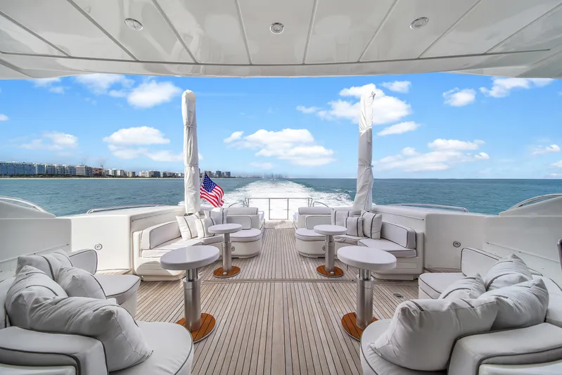  Yacht Photos Pics Luxurious 2002 Mangusta 108 yacht deck with plush seating and ocean view.