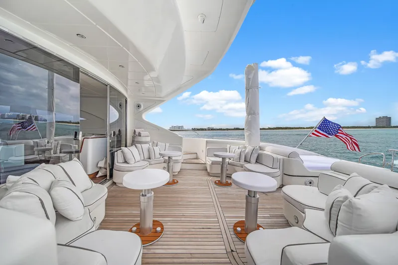  Yacht Photos Pics Luxurious 2002 Mangusta 108 yacht deck with elegant seating and ocean view.