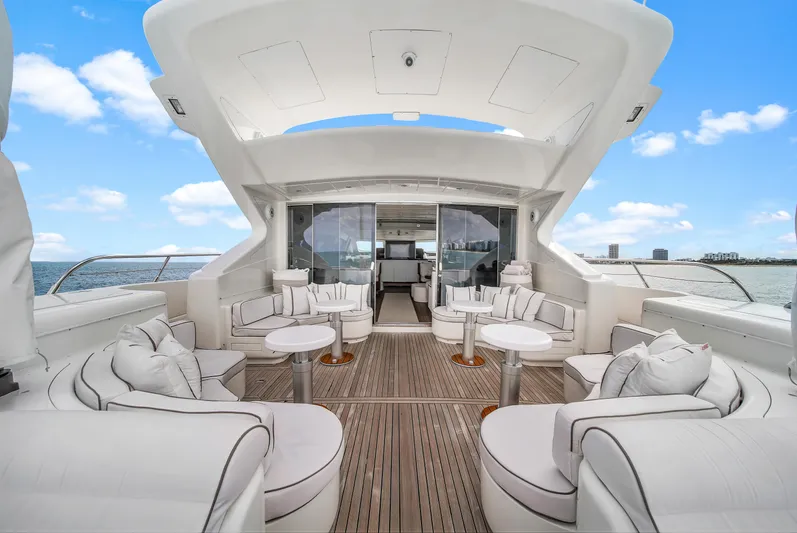  Yacht Photos Pics Luxurious 2002 Mangusta 108 yacht with elegant white seating and open deck design.