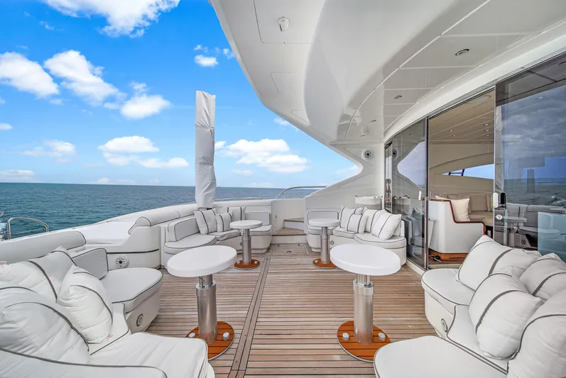  Yacht Photos Pics Luxurious 2002 Mangusta 108 yacht deck with plush seating and ocean view.