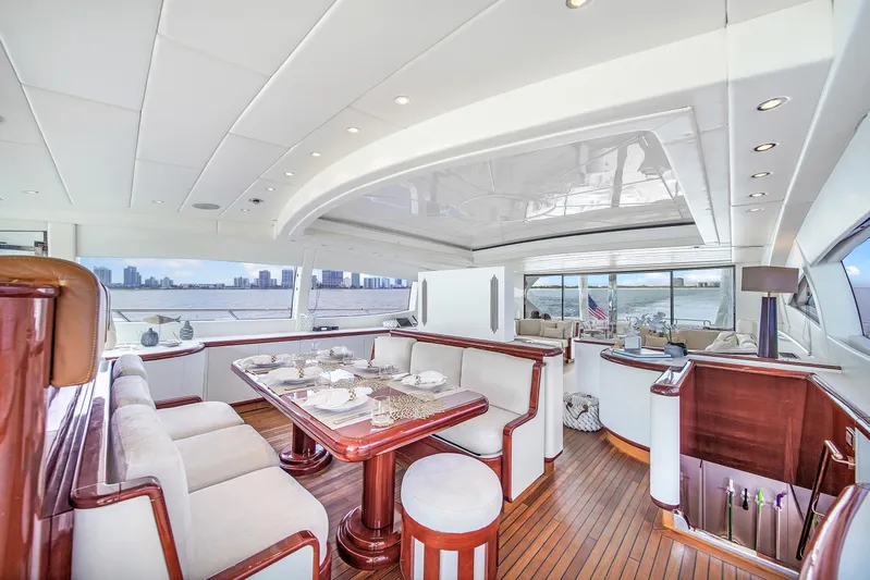  Yacht Photos Pics Luxurious interior of 2002 Mangusta 108 yacht with elegant dining area and panoramic views.
