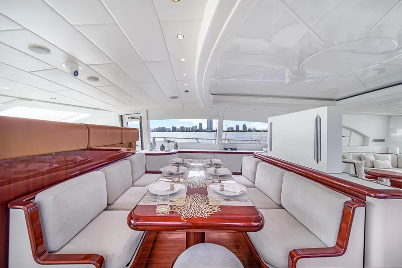  Yacht Photos Pics Luxurious interior of 2002 Mangusta 108 yacht with elegant dining area and panoramic views.