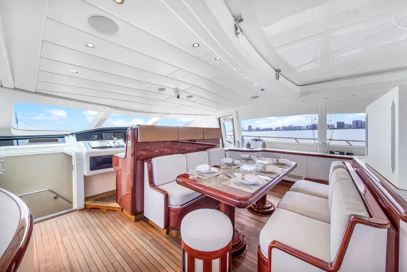  Yacht Photos Pics Luxurious interior of 2002 Mangusta 108 yacht with elegant dining area and panoramic views.