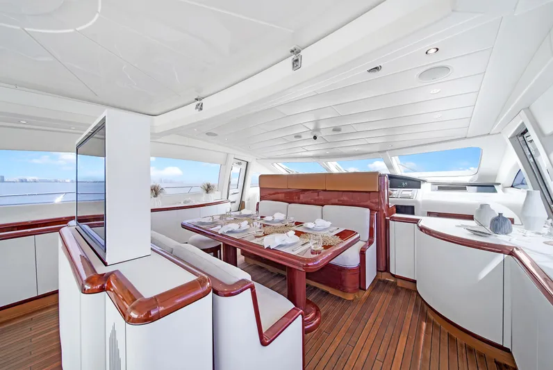  Yacht Photos Pics Luxurious interior of 2002 Mangusta 108 yacht with elegant dining area and panoramic windows.