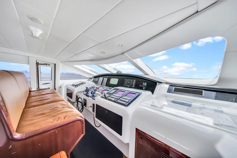  Yacht Photos Pics Luxurious 2002 Mangusta 108 yacht cockpit with modern navigation equipment and panoramic windows.