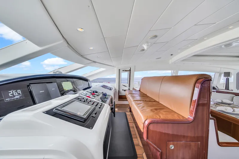  Yacht Photos Pics Luxurious interior of 2002 Mangusta 108 yacht with leather seating and modern controls.