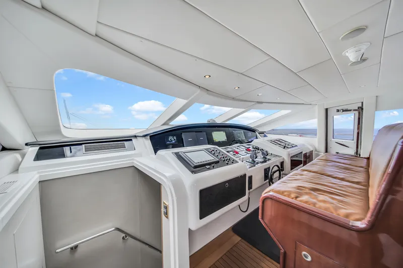  Yacht Photos Pics Luxurious 2002 Mangusta 108 yacht interior with modern navigation controls and leather seating.