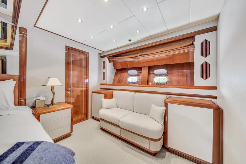  Yacht Photos Pics Luxurious interior of 2002 Mangusta 108 yacht with elegant wood finishes and cozy seating.