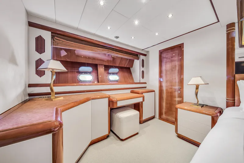  Yacht Photos Pics Luxurious interior of 2002 Mangusta 108 yacht with elegant wood finishes and modern lighting.