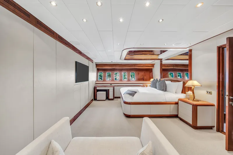  Yacht Photos Pics Luxurious interior of 2002 Mangusta 108 yacht, featuring elegant bedroom and modern design.