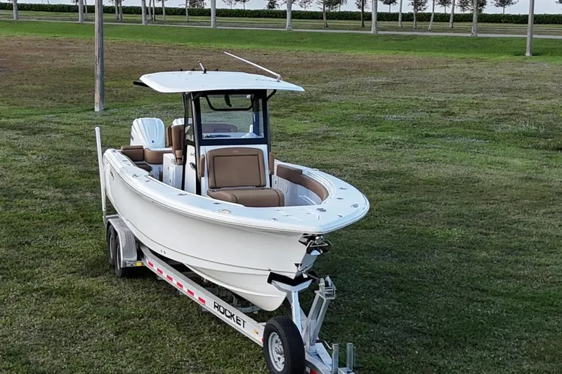  Yacht Photos Pics 2023 Seahunt 30 GameFish Coffin Box boat on trailer, parked on grass.