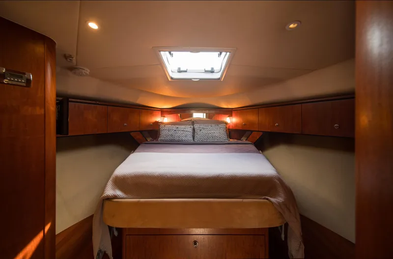 T 2 Yacht Photos Pics Interior cabin of 2006 Tiara Yachts 4300 Sovran with cozy bed and wooden cabinetry.