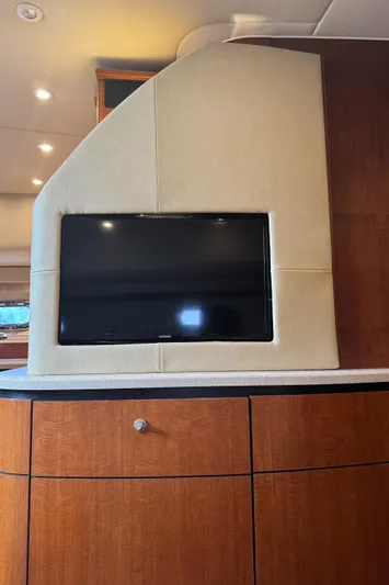 T 2 Yacht Photos Pics 2006 Tiara Yachts 4300 Sovran interior with mounted TV and wooden cabinetry.
