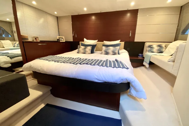 Aum Yacht Photos Pics Luxurious bedroom interior of 2013 Princess V57 yacht with modern decor and cozy bedding.