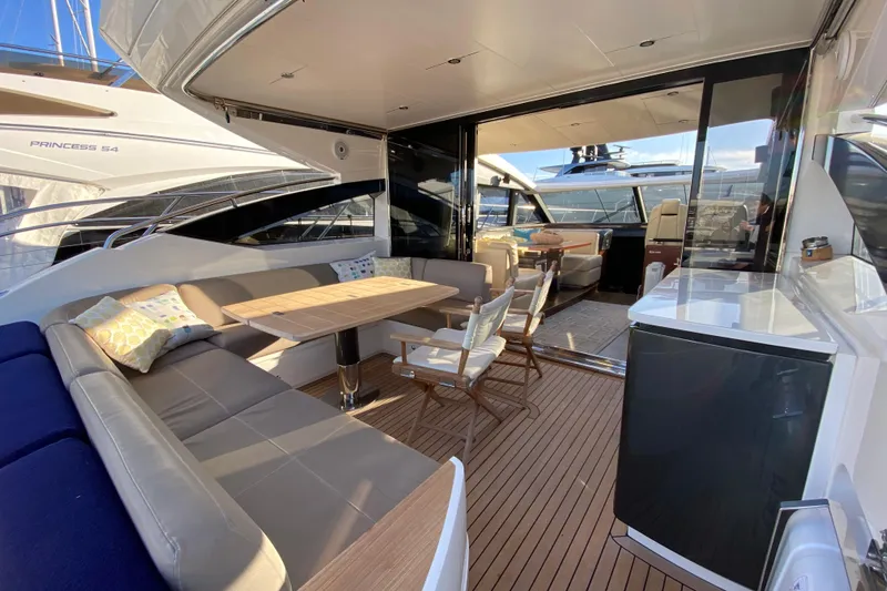 Aum Yacht Photos Pics Luxurious 2013 Princess V57 yacht interior with elegant seating and dining area.