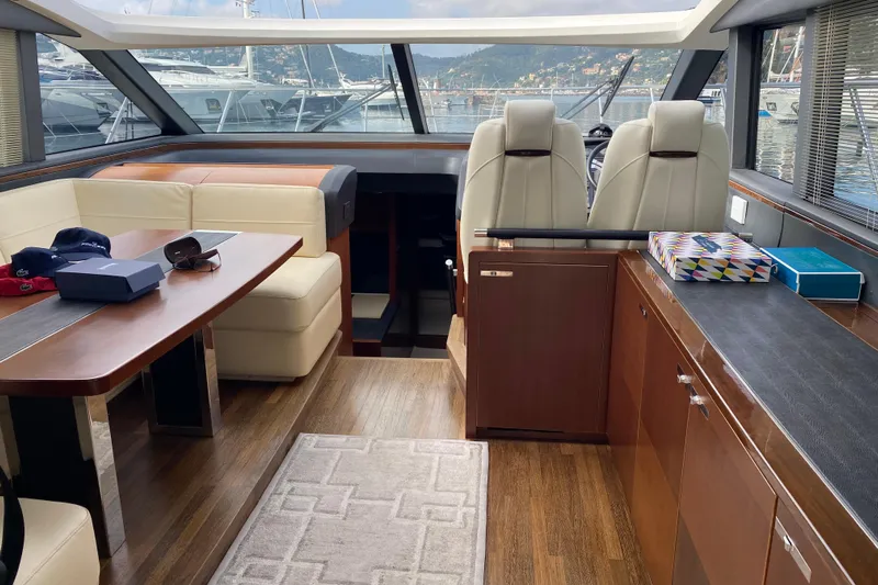 Aum Yacht Photos Pics Luxurious interior of a 2013 Princess V57 yacht with elegant seating and modern design.
